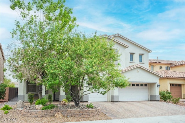 6937 Puetollano Dr, North Las Vegas, NV 89084 - view of front of home featuring decorative driveway, stucco siding, and a tile roof