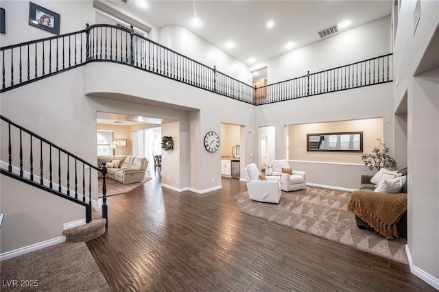 6937 Puetollano Dr, North Las Vegas, NV 89084 - living area with stairs, a towering ceiling, wood finished floors, and recessed lighting