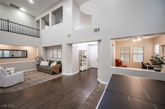 6937 Puetollano Dr, North Las Vegas, NV 89084 - living area featuring wood finished floors, ceiling fan, and a towering ceiling