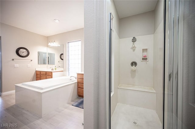 6937 Puetollano Dr, North Las Vegas, NV 89084 - full bath with a stall shower, vanity, a garden tub, and wood finished floors