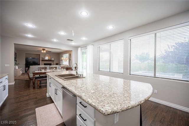 6937 Puetollano Dr, North Las Vegas, NV 89084 - kitchen with dishwasher, white cabinets, a ceiling fan, a center island with sink, and recessed lighting