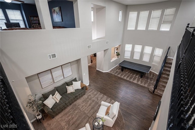 6937 Puetollano Dr, North Las Vegas, NV 89084 - living area featuring wood finished floors, stairway, and a towering ceiling