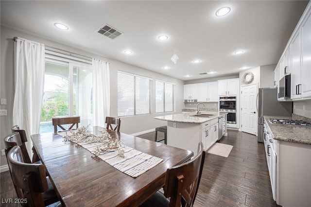 6937 Puetollano Dr, North Las Vegas, NV 89084 - dining space with recessed lighting and dark wood finished floors