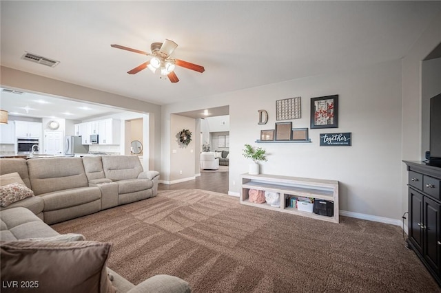 6937 Puetollano Dr, North Las Vegas, NV 89084 - carpeted living room featuring a ceiling fan and baseboards
