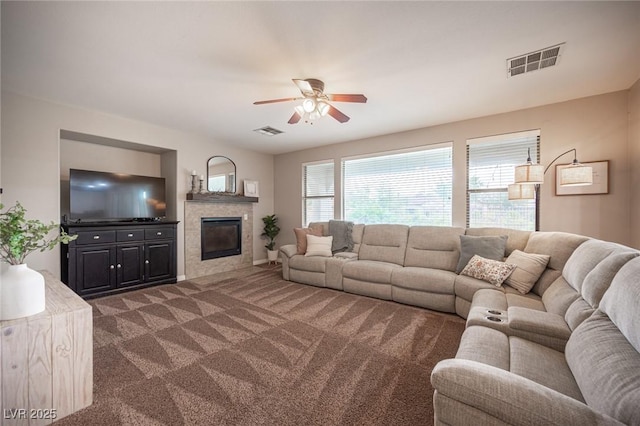 6937 Puetollano Dr, North Las Vegas, NV 89084 - living room featuring ceiling fan, dark colored carpet, and a tiled fireplace