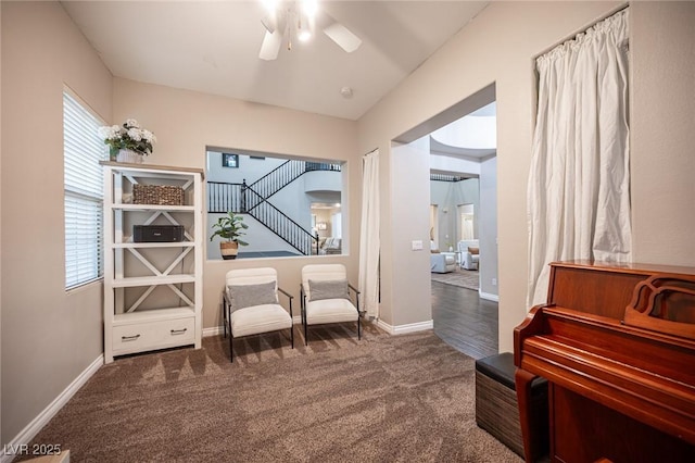 6937 Puetollano Dr, North Las Vegas, NV 89084 - living area with carpet floors, ceiling fan, arched walkways, and stairs