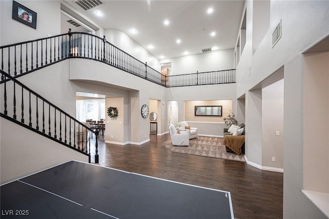 6937 Puetollano Dr, North Las Vegas, NV 89084 - foyer featuring wood finished floors, stairway, a towering ceiling, and recessed lighting