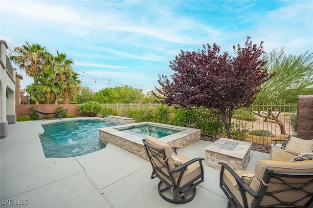 6937 Puetollano Dr, North Las Vegas, NV 89084 - view of swimming pool featuring an outdoor fire pit, a patio area, a fenced backyard, and a pool with connected hot tub