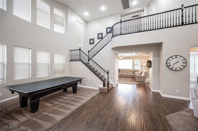 6937 Puetollano Dr, North Las Vegas, NV 89084 - game room featuring wood finished floors, a towering ceiling, and a ceiling fan