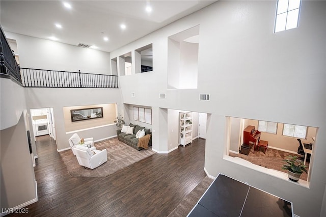6937 Puetollano Dr, North Las Vegas, NV 89084 - living room with wood finished floors, recessed lighting, a towering ceiling, and stairway