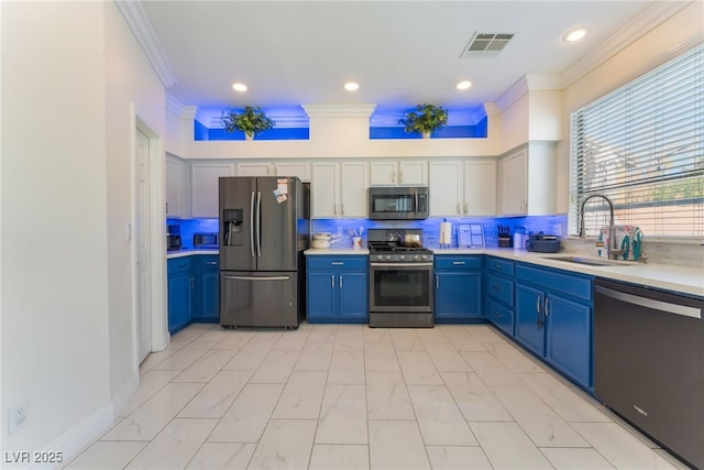 2912 Hot Cider Ave, North Las Vegas, NV 89031 - kitchen featuring stainless steel appliances, crown molding, blue cabinetry, light countertops, and light marble finish floors
