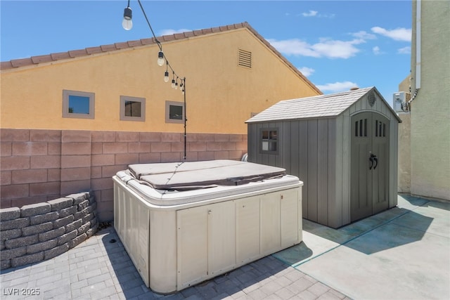 2912 Hot Cider Ave, North Las Vegas, NV 89031 - view of patio with a hot tub and a storage unit