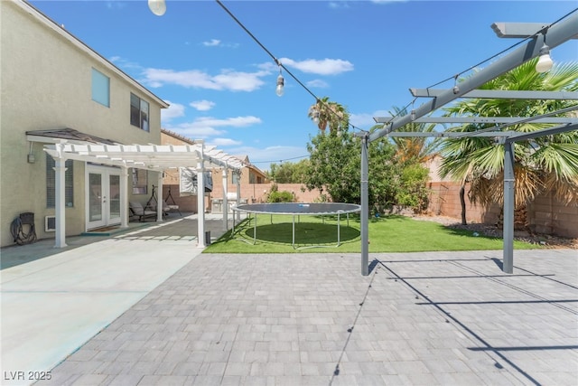 2912 Hot Cider Ave, North Las Vegas, NV 89031 - fenced backyard featuring a pergola, a trampoline, french doors, and a patio