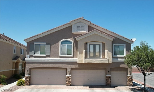 1073 Pleasure Ln Unit 2, Henderson, NV 89002 - view of front facade with a garage, stucco siding, and driveway
