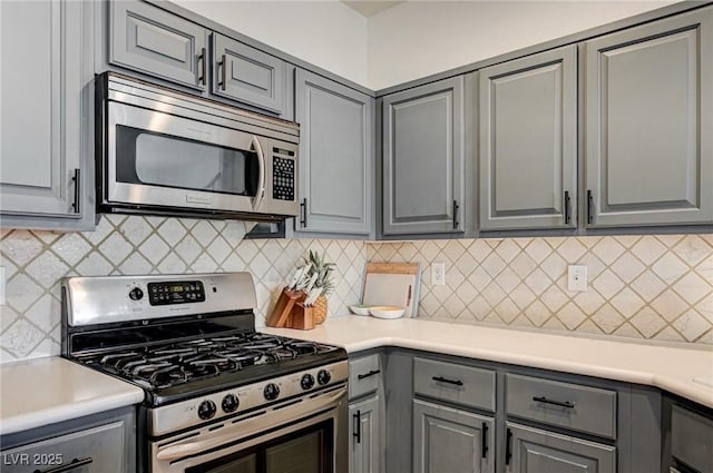 1073 Pleasure Ln Unit 2, Henderson, NV 89002 - kitchen with appliances with stainless steel finishes, gray cabinets, light countertops, and tasteful backsplash