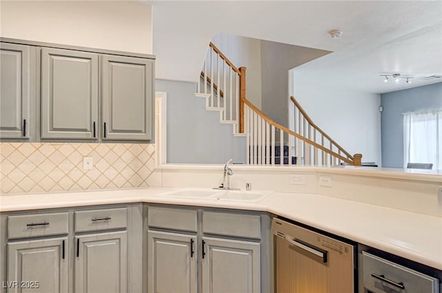 1073 Pleasure Ln Unit 2, Henderson, NV 89002 - kitchen featuring dishwasher, gray cabinetry, backsplash, and light countertops