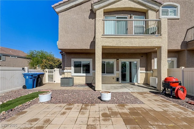 1073 Pleasure Ln Unit 2, Henderson, NV 89002 - back of house featuring stucco siding, a patio, a fenced backyard, and a balcony