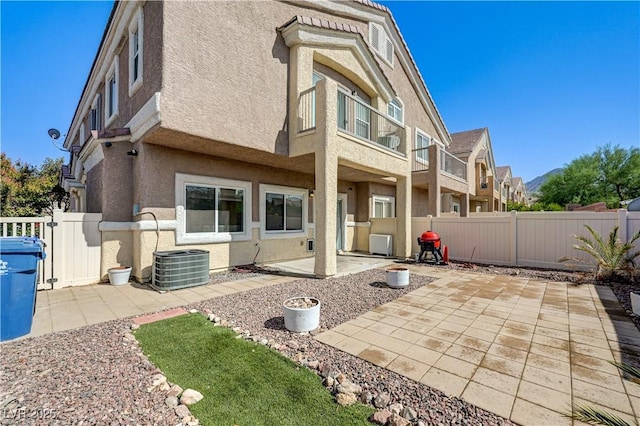 1073 Pleasure Ln Unit 2, Henderson, NV 89002 - rear view of house with stucco siding, a patio area, and a fenced backyard