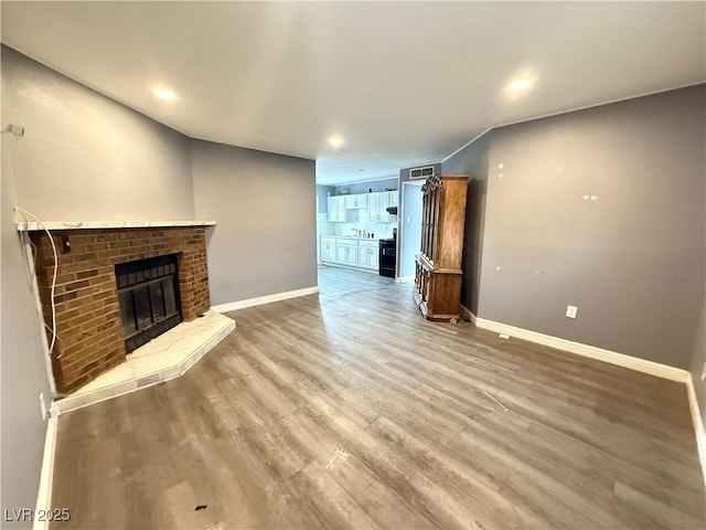 15 Washington Way, Henderson, NV 89015 - unfurnished living room featuring wood finished floors, a brick fireplace, and recessed lighting