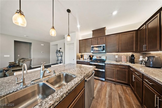 3603 E Umatilla Ave, Pahrump, NV 89061 - kitchen with stainless steel appliances, tasteful backsplash, decorative light fixtures, and dark wood-type flooring