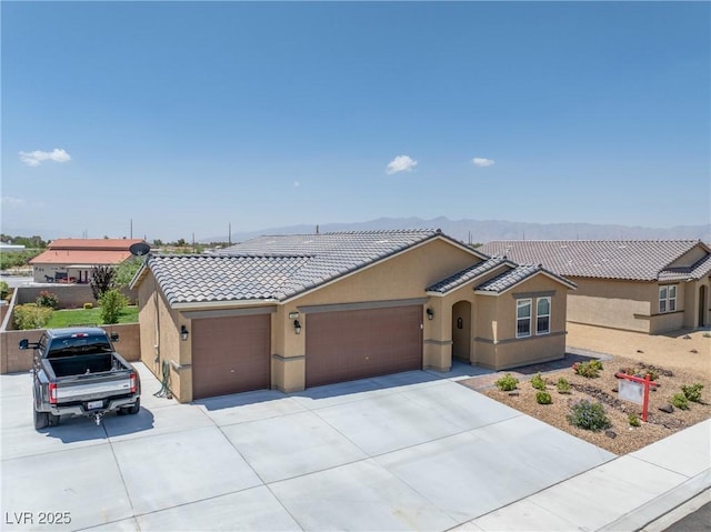 3603 E Umatilla Ave, Pahrump, NV 89061 - ranch-style home with an attached garage, driveway, stucco siding, and a tile roof
