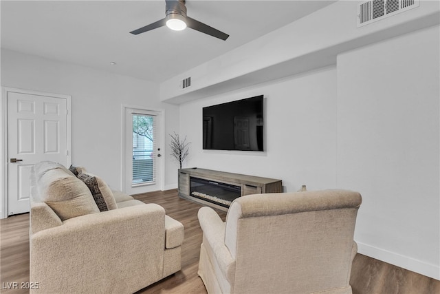 833 Aspen Peak Loop Unit 613, Henderson, NV 89011 - living room with a ceiling fan, wood finished floors, and a glass covered fireplace