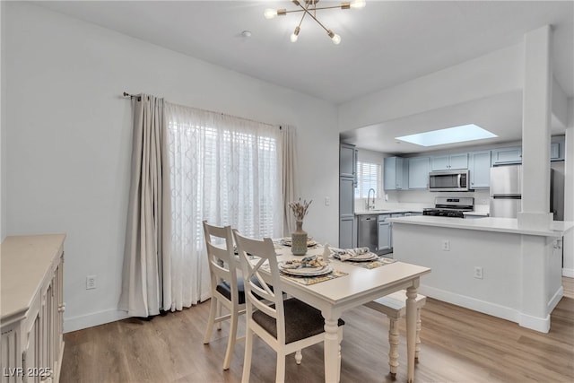 833 Aspen Peak Loop Unit 613, Henderson, NV 89011 - dining area featuring a skylight, light wood-type flooring, and a chandelier