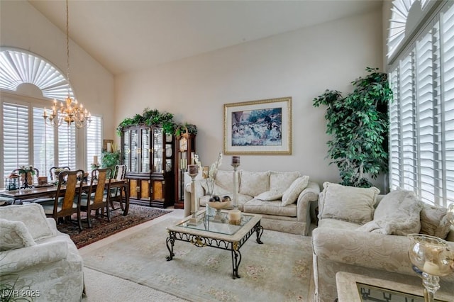 7836 Silver Plateau Ave, Las Vegas, NV 89128 - living room featuring high vaulted ceiling and a chandelier