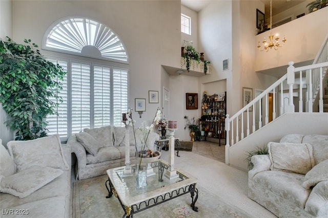 7836 Silver Plateau Ave, Las Vegas, NV 89128 - living room featuring stairs, a chandelier, a high ceiling, and carpet