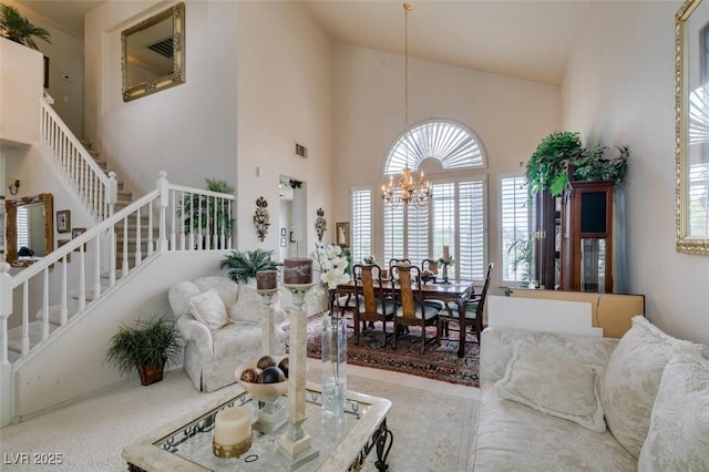 7836 Silver Plateau Ave, Las Vegas, NV 89128 - living area featuring high vaulted ceiling, stairway, a chandelier, and plenty of natural light