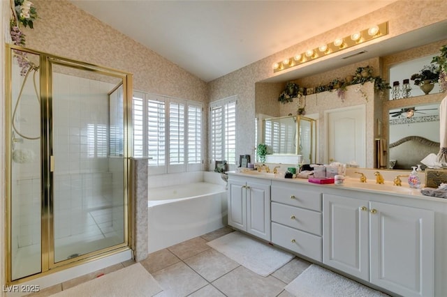 7836 Silver Plateau Ave, Las Vegas, NV 89128 - full bath with double vanity, vaulted ceiling, a bath, a stall shower, and tile patterned flooring