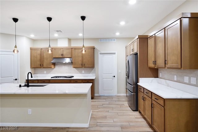 8478 Hawks View St, Las Vegas, NV 89113 - kitchen with under cabinet range hood, freestanding refrigerator, backsplash, pendant lighting, and recessed lighting
