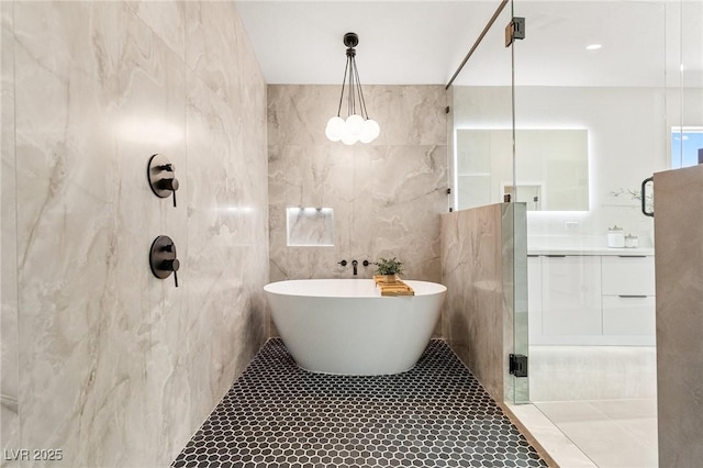 10707 Sleepy Mist Ct, Las Vegas, NV 89141 - full bathroom with tile walls, a walk in shower, a soaking tub, vanity, and tile patterned floors
