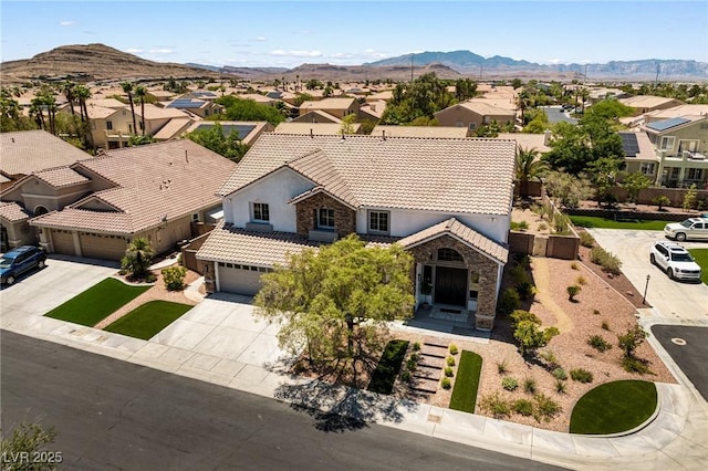 10707 Sleepy Mist Ct, Las Vegas, NV 89141 - view of front of house featuring driveway, a residential view, a tile roof, and stone siding