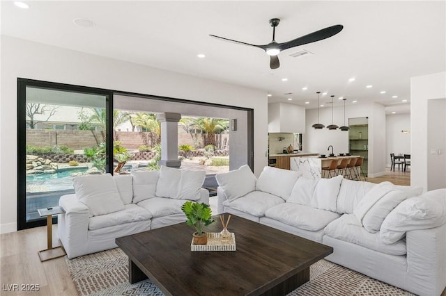 10707 Sleepy Mist Ct, Las Vegas, NV 89141 - living room featuring light wood-style floors, a ceiling fan, and recessed lighting