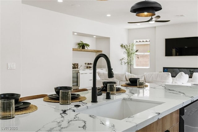 10707 Sleepy Mist Ct, Las Vegas, NV 89141 - kitchen with light stone counters, ceiling fan, recessed lighting, open shelves, and dishwashing machine