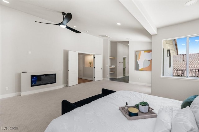 10707 Sleepy Mist Ct, Las Vegas, NV 89141 - bedroom with carpet, recessed lighting, a glass covered fireplace, connected bathroom, and ceiling fan