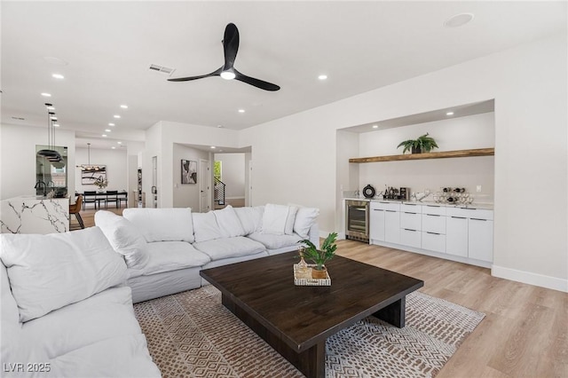 10707 Sleepy Mist Ct, Las Vegas, NV 89141 - living area featuring wine cooler, light wood finished floors, bar, recessed lighting, and ceiling fan