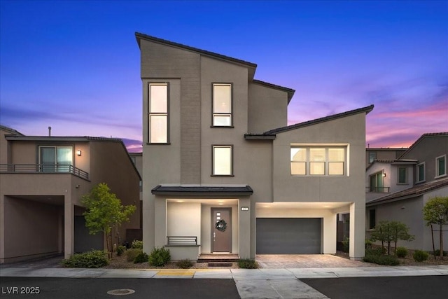 635 Pyrite Will St, Las Vegas, NV 89138 - view of front facade with stucco siding, an attached garage, and decorative driveway
