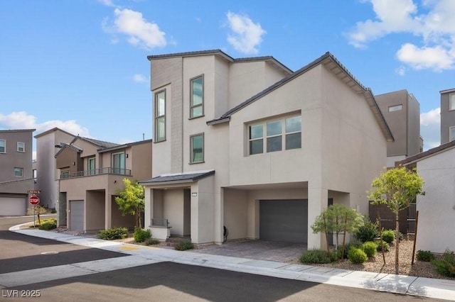 635 Pyrite Will St, Las Vegas, NV 89138 - view of front of home with stucco siding, an attached garage, and a residential view