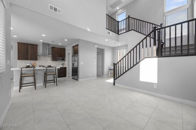 635 Pyrite Will St, Las Vegas, NV 89138 - living room with healthy amount of natural light, stairway, a towering ceiling, light tile patterned flooring, and recessed lighting