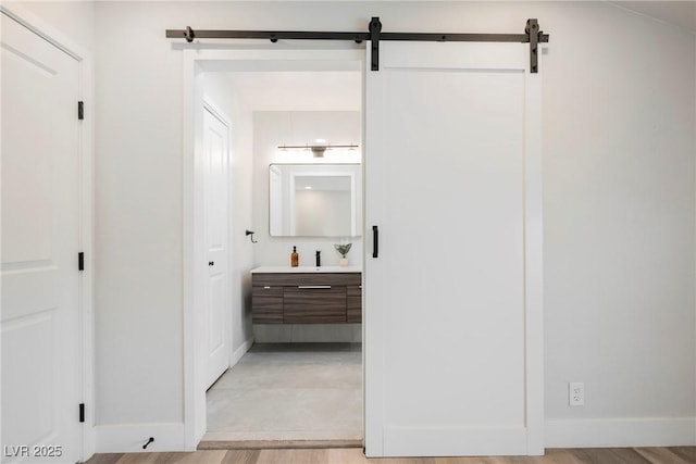 1712 E Oakey Blvd, Las Vegas, NV 89104 - hallway featuring a barn door and light wood-style flooring