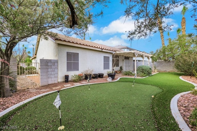 1078 Broomfield Dr, Henderson, NV 89074 - rear view of property featuring a putting area, stucco siding, a tile roof, a pergola, and a fenced backyard