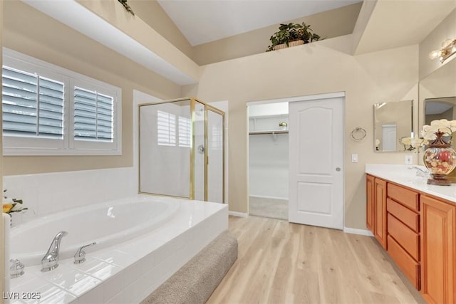 1078 Broomfield Dr, Henderson, NV 89074 - full bath with a stall shower, a bath, double vanity, wood finished floors, and a walk in closet