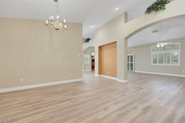 1078 Broomfield Dr, Henderson, NV 89074 - unfurnished living room with arched walkways, a ceiling fan, light wood finished floors, a chandelier, and recessed lighting