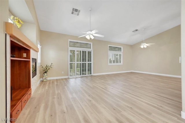 1078 Broomfield Dr, Henderson, NV 89074 - unfurnished living room featuring ceiling fan, light wood-style floors, and vaulted ceiling