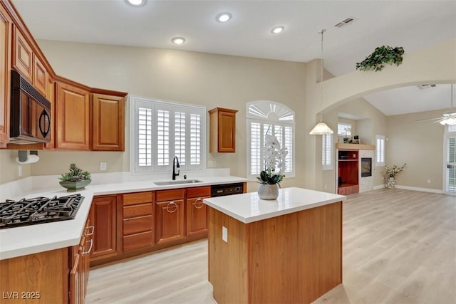 1078 Broomfield Dr, Henderson, NV 89074 - kitchen featuring black appliances, lofted ceiling, open floor plan, light wood-type flooring, and ceiling fan
