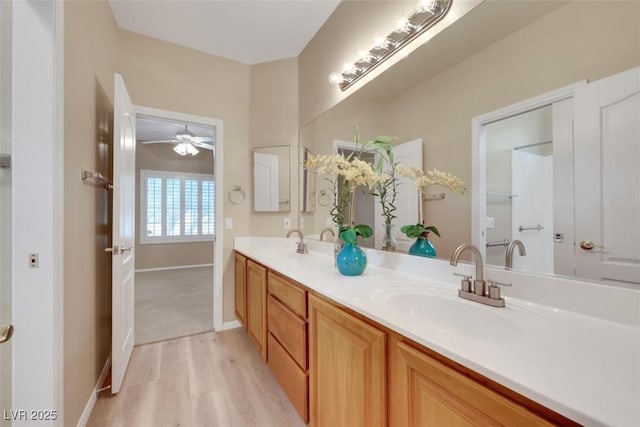 1078 Broomfield Dr, Henderson, NV 89074 - bathroom with double vanity, wood finished floors, and a ceiling fan