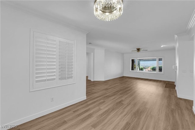 2167 Fairweather St, Henderson, NV 89052 - unfurnished living room featuring wood finished floors, crown molding, ceiling fan, and a chandelier