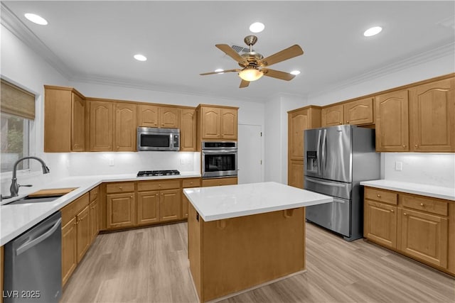 2167 Fairweather St, Henderson, NV 89052 - kitchen with stainless steel appliances, light wood-style flooring, a kitchen island, ceiling fan, and light countertops